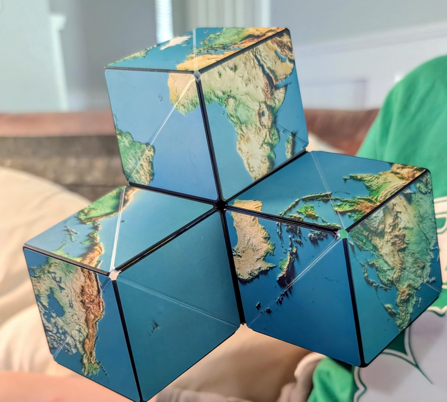 Customer photo of three Shashibo Earth cubes connected magnetically into one larger structure