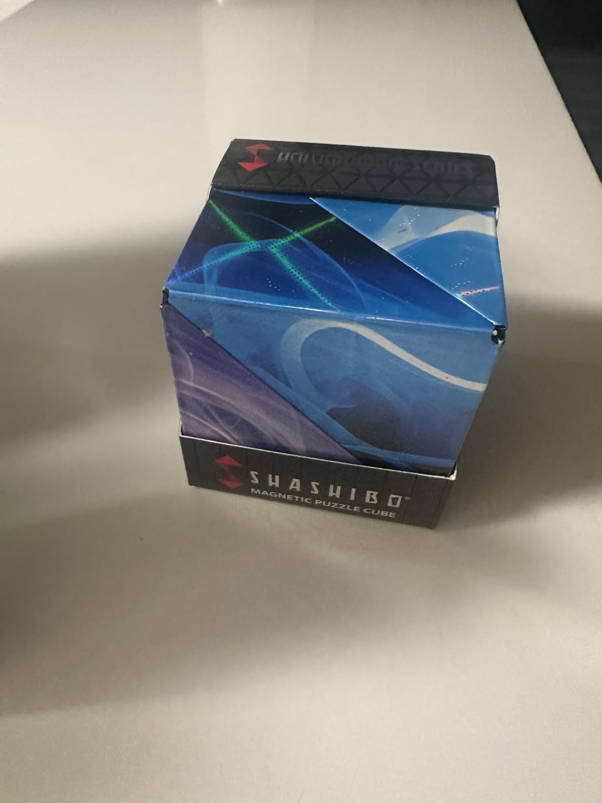 Customer photo of a sealed Shashibo box labeled magnetic puzzle cube, printed with blue and purple artwork